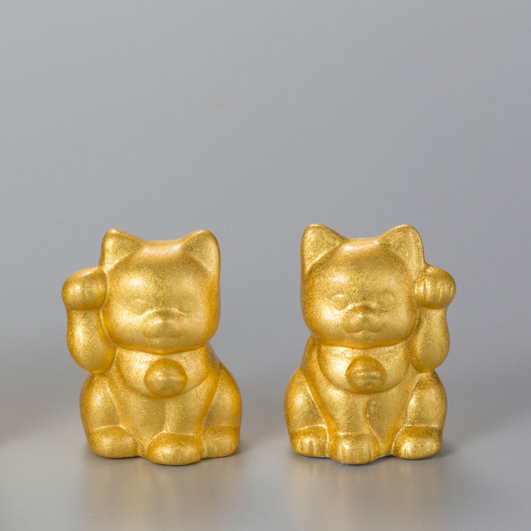 A decorative Maneki Neko lucky cat with a raised left paw, finished with Hakuichi foil craftsmanship. It works well as a gift item, souvenir, shop display, or small interior accent connected to Japanese good-luck culture.