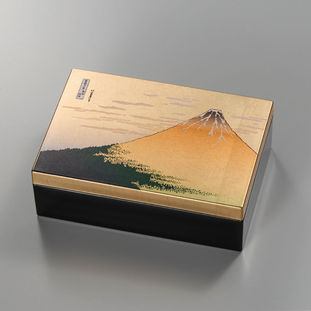 A decorative storage box with Japanese art-inspired design and foil accents. It is suitable for keeping small accessories, presenting gifts, or adding a compact Japanese craft item to gift and home interior displays.